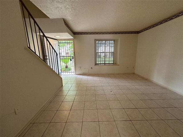 interior space with light tile patterned floors and a textured ceiling