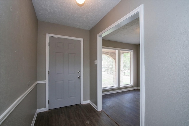 foyer entrance featuring dark hardwood / wood-style floors and a textured ceiling