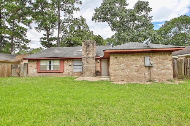 rear view of property with a lawn