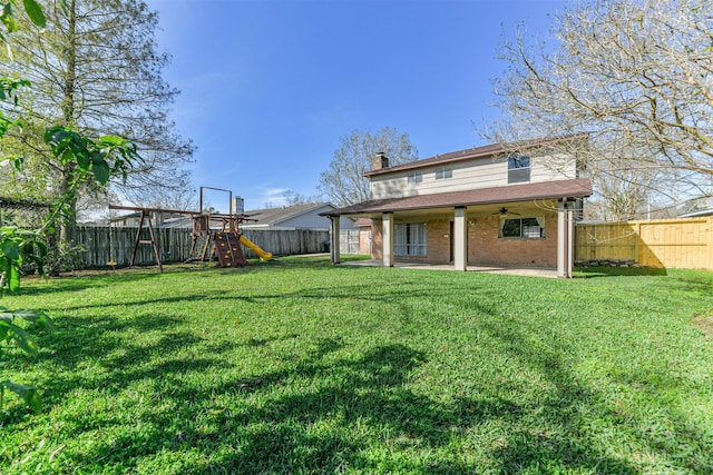 back of house with a playground, ceiling fan, a patio area, and a lawn