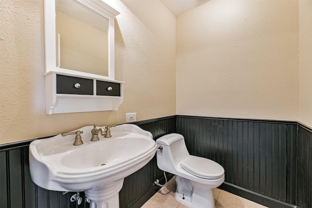 bathroom featuring tile patterned floors, toilet, and sink