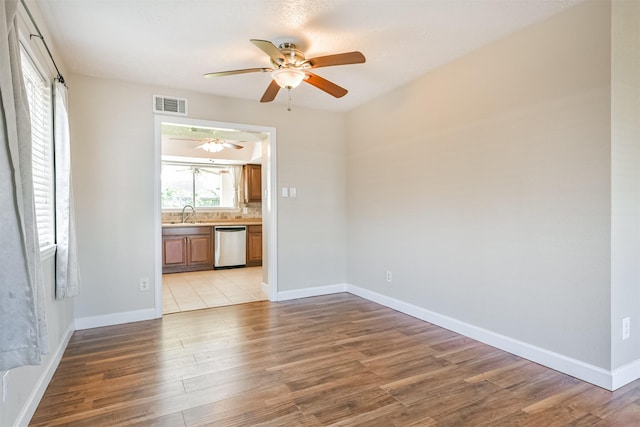 unfurnished room featuring light wood-type flooring and ceiling fan