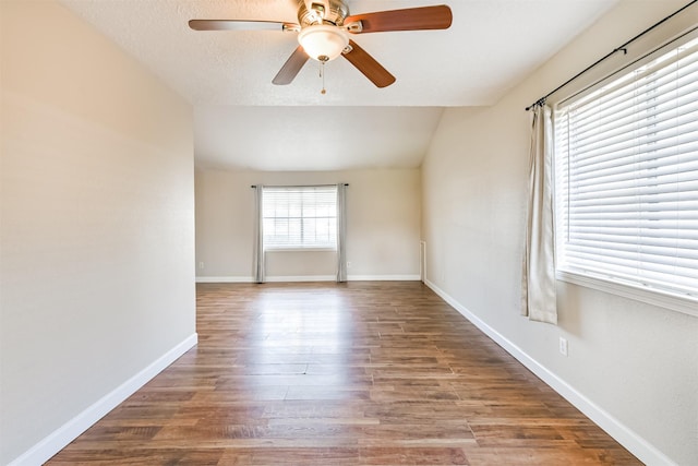 spare room with hardwood / wood-style flooring, ceiling fan, and lofted ceiling