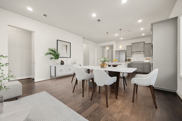 dining space featuring dark hardwood / wood-style flooring