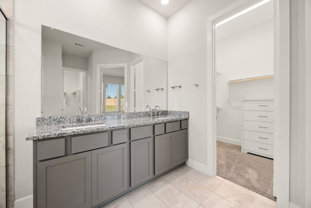 bathroom with tile patterned flooring and vanity