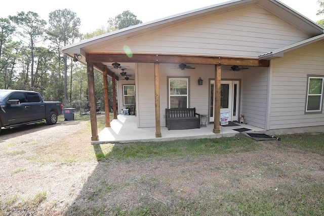 back of house featuring a porch and ceiling fan