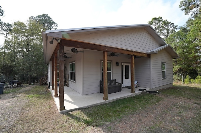 view of front of home featuring ceiling fan and a patio area