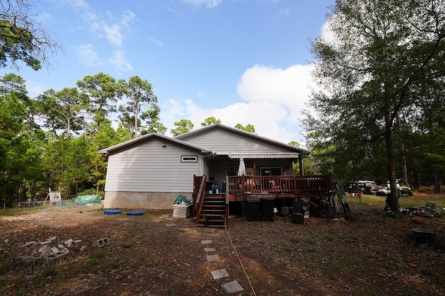 rear view of property with a wooden deck