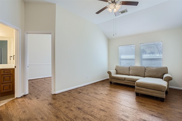 living room with hardwood / wood-style flooring, vaulted ceiling, and ceiling fan