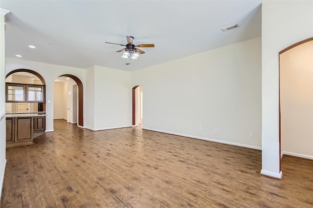 unfurnished living room featuring wood-type flooring and ceiling fan