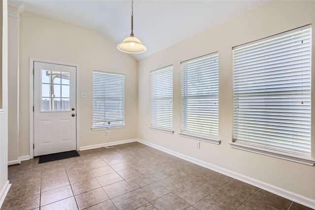 foyer with tile patterned floors and lofted ceiling