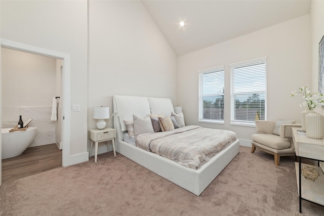 carpeted bedroom featuring high vaulted ceiling