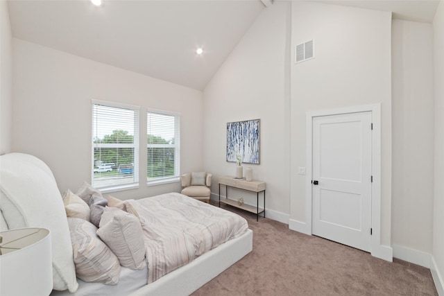 bedroom featuring beamed ceiling, high vaulted ceiling, and light colored carpet