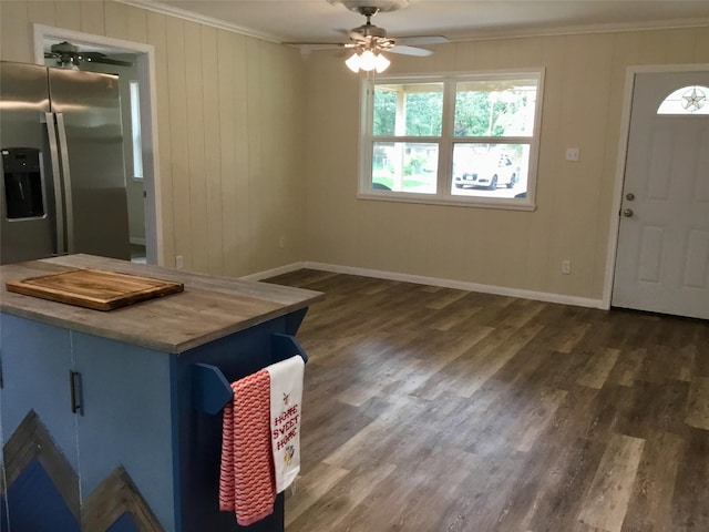 kitchen with blue cabinetry, ceiling fan, wooden counters, dark hardwood / wood-style floors, and ornamental molding