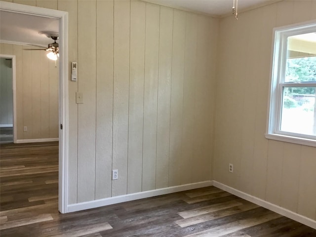 empty room featuring ceiling fan and dark hardwood / wood-style flooring