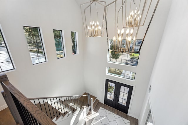 entrance foyer featuring hardwood / wood-style floors, french doors, and a high ceiling