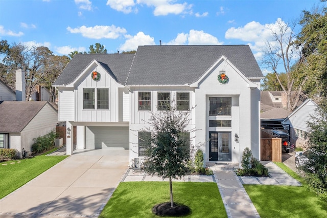 view of front of house with french doors, a front lawn, and a garage