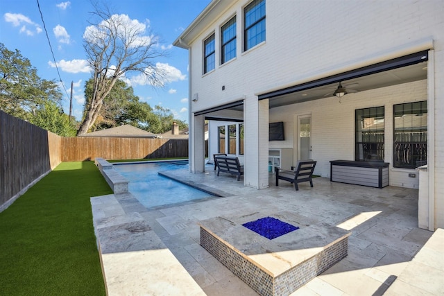 view of swimming pool with outdoor lounge area, ceiling fan, and a patio area