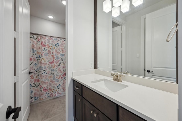 bathroom featuring a shower with shower curtain and vanity