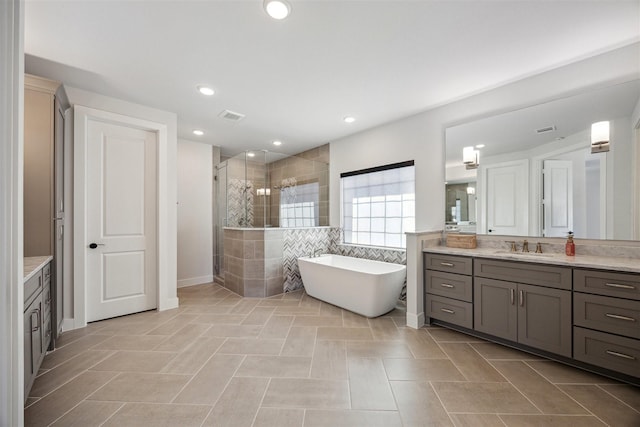 bathroom with tile patterned flooring, vanity, and independent shower and bath