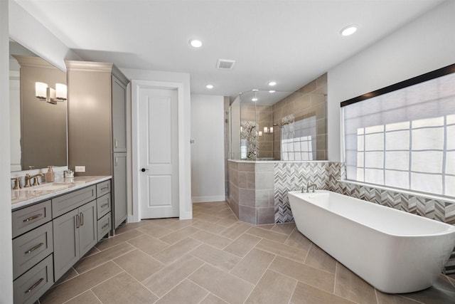 bathroom featuring tile patterned flooring, vanity, and independent shower and bath