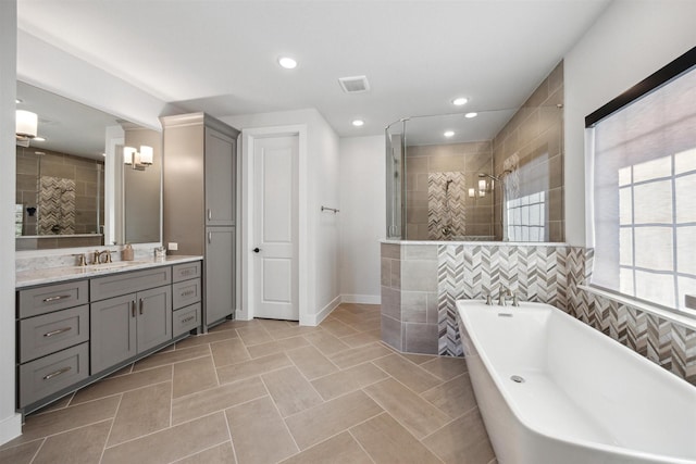 bathroom with tile patterned flooring, vanity, and independent shower and bath