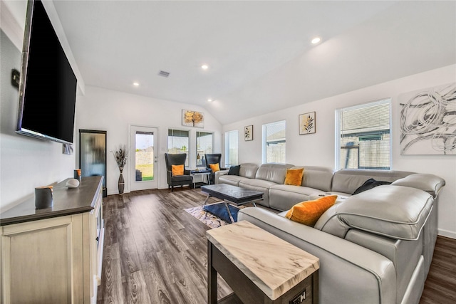 living room featuring dark hardwood / wood-style flooring and vaulted ceiling