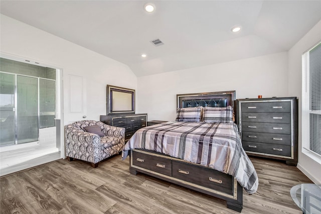 bedroom with hardwood / wood-style flooring and vaulted ceiling