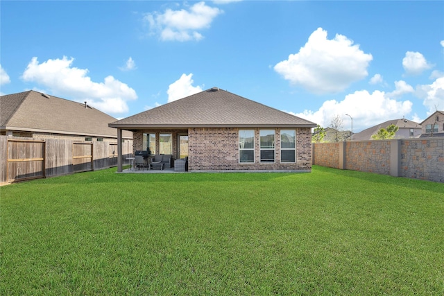 rear view of house featuring a patio area and a lawn