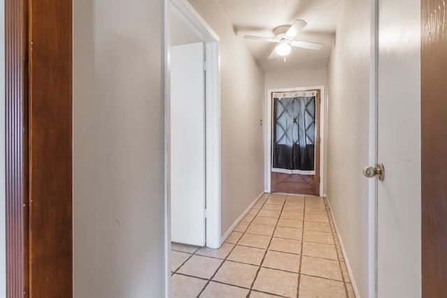 hall featuring light tile patterned floors