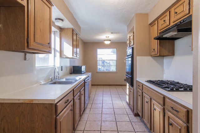 kitchen featuring sink, light tile patterned floors, and black appliances