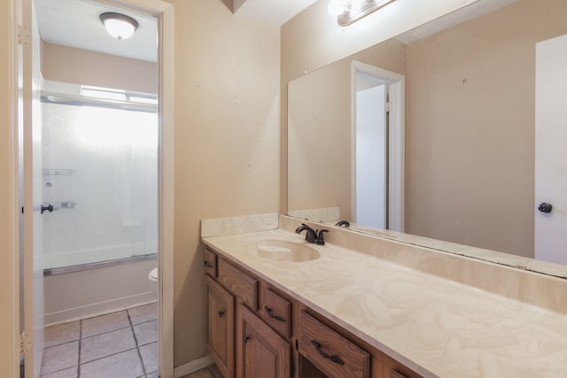 full bathroom featuring tile patterned floors, vanity, enclosed tub / shower combo, and toilet