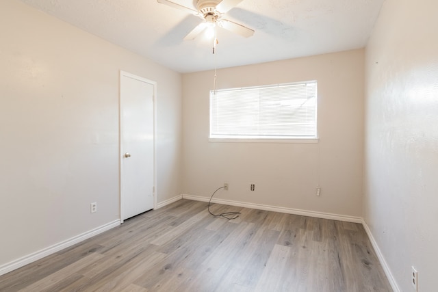 spare room with ceiling fan and light wood-type flooring