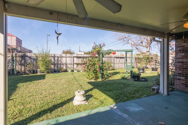 view of yard featuring a patio area and ceiling fan