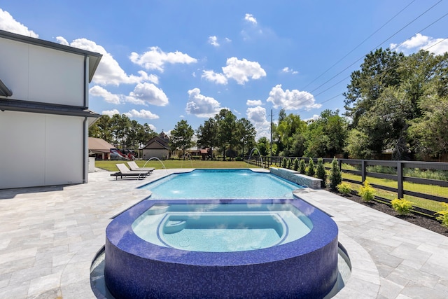 view of swimming pool featuring pool water feature, an in ground hot tub, and a patio