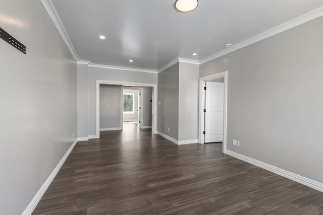 empty room featuring dark hardwood / wood-style flooring and crown molding