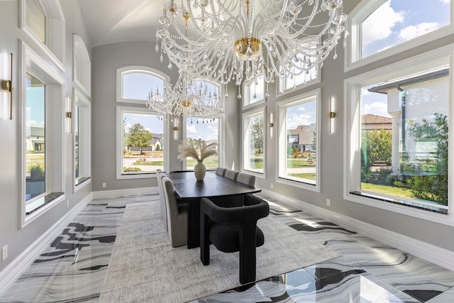 sunroom featuring a notable chandelier and a healthy amount of sunlight