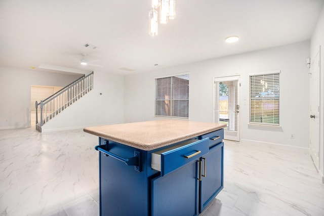 kitchen with pendant lighting, a center island, blue cabinetry, and a breakfast bar area