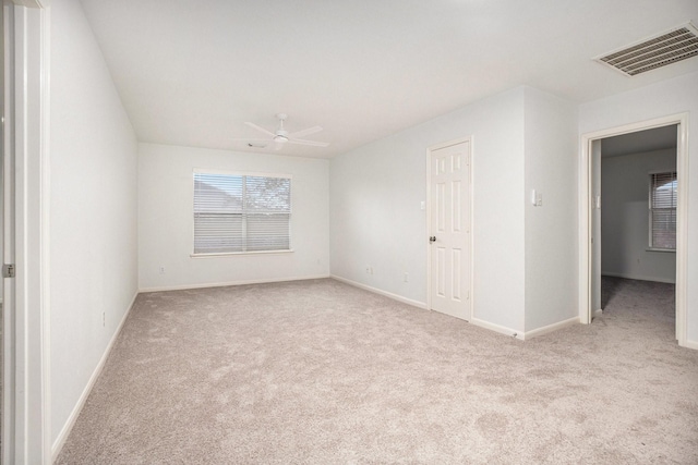 empty room with light carpet and ceiling fan