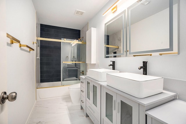 full bathroom featuring vanity, toilet, and enclosed tub / shower combo