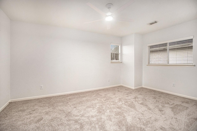 carpeted spare room featuring ceiling fan