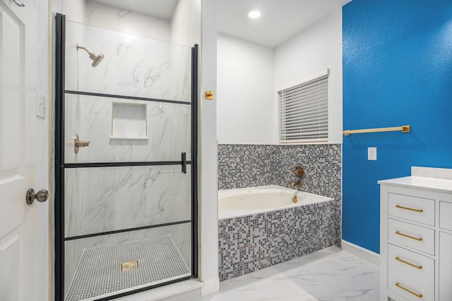 bathroom with vanity and separate shower and tub