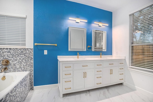 bathroom with vanity and tiled tub