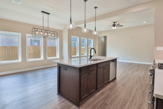 kitchen featuring pendant lighting, sink, ceiling fan, appliances with stainless steel finishes, and dark brown cabinetry