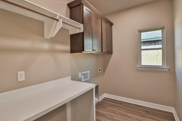 laundry room featuring cabinets, washer hookup, light hardwood / wood-style floors, and electric dryer hookup