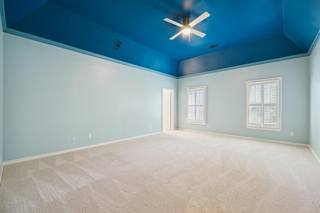 carpeted empty room featuring crown molding, ceiling fan, and lofted ceiling