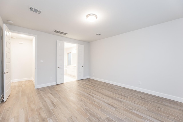 unfurnished room with light hardwood / wood-style flooring