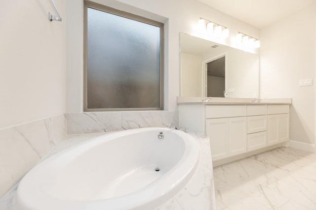 bathroom with vanity and a relaxing tiled tub