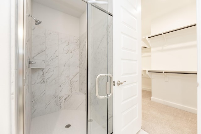 bathroom with a shower with shower door