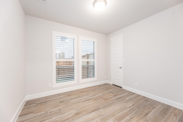 spare room with light wood-type flooring